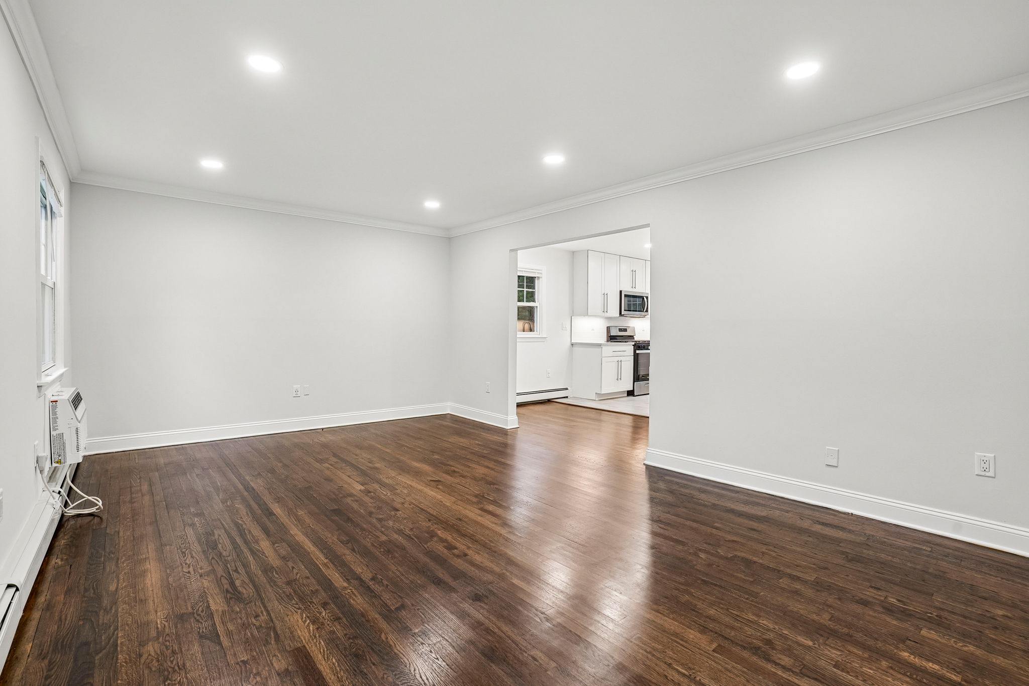 A room with wooden floors and white walls.